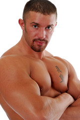 A muscular bodybuilder with his arms folded