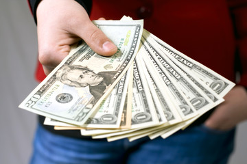 Hand giving american dollars