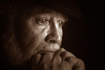 Dramatic portrait of a elderly man contemplating retirement