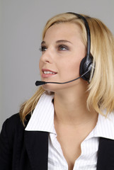 a friendly woman with blond hair and headphone