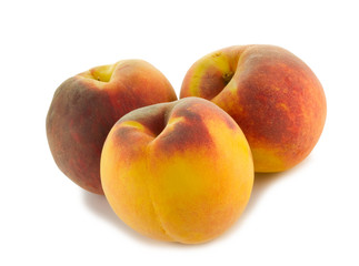 Fototapeta na wymiar three full peaches isolated on white background