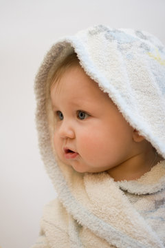Portrait of child after by bath in a white dressing-gown