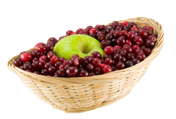 red cranberries and apple in crib isolated on white background
