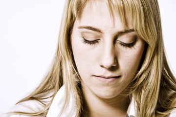 Studio portrait of a long blond girl looking relaxed