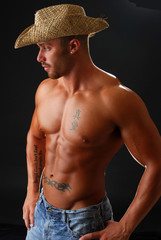 A msucular cowboy without a shirt