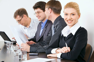 Confident people sitting at the table at business meeting