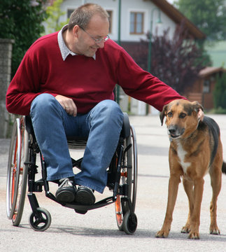 Man in a wheelchair with a dog