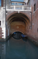Venetian building with arch over canal