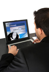 Young  business man working at laptop. Isolated on white.