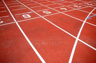 numbers of a racetrack, on red tarmac, for runners