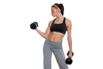 Young woman working out with dumbbells