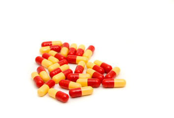 Red and yellow capsules isolated on white