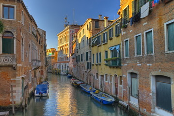 Fototapeta na wymiar A typical canal in Venice with beautifully colored houses.