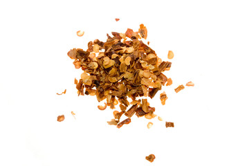 A small pile of crushed red pepper isolated on white.