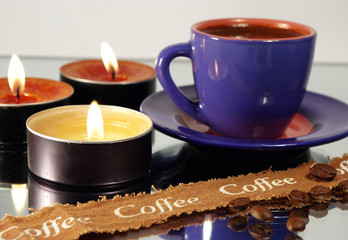 cup of black hot coffee and candles