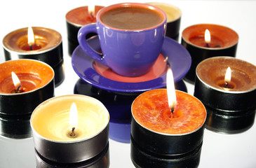 cup of black hot coffee and candles