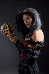 Beautiful latino woman with skull in her hands