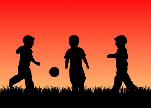 kids play ball on gras at sunset