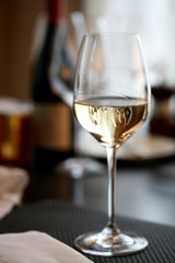 Wine bottles reflected in a wine glass