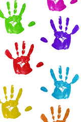 close up colorful child handprints on white