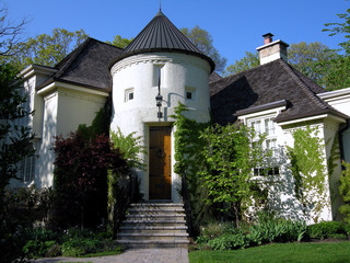 Stucco house with turret over entrance © Spiroview Inc.