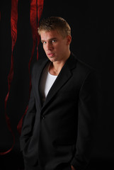 Fototapeta premium A man in dark clothing slips out of the shadows