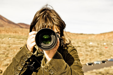 Fototapeta premium Brown haired woman taking picture.