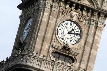 a clock tower with a sky background in noon time