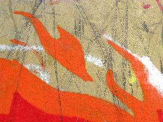 Colorful detail of grunge fire in the wall of building