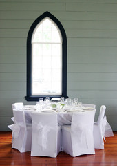 Tables decorated at a wedding reception held in a church.