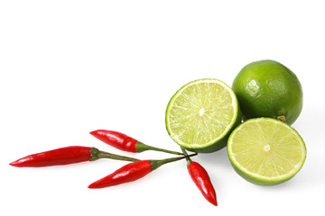 Limes and chilli peppers, isolated on white.  
