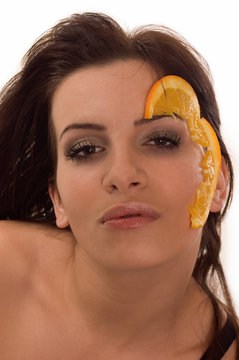 A slace of orange on woman's face