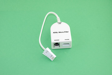 An ADSL micro filter set against a green background