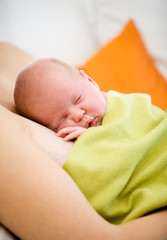 Mother holding sleeping baby girl