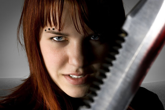 Girl with red hair holding with an evil smile