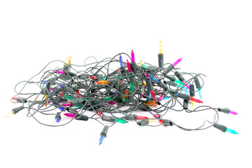 Colors Christmas lights turned off on white background .