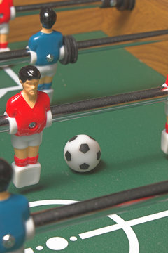 A miniature tabletop foosball arcade type game.