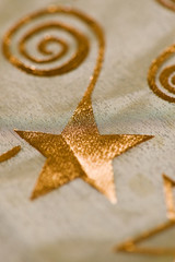 Fototapeta na wymiar Seasonal motifs, stars and swirls on a tablecloth