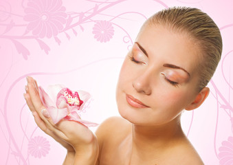 Fototapeta premium Beautiful girl holding orchid flower in her hands 