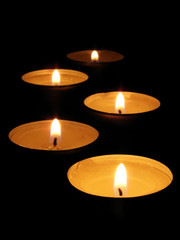 Burning candle isolated on black background