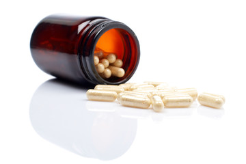 Capsules, shallow DOF. Reflected on white background