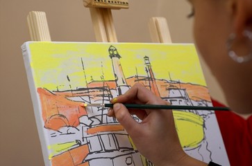 Artist at work - woman painting a picture of a ship