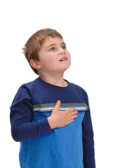 Child with hand on chest looking up
