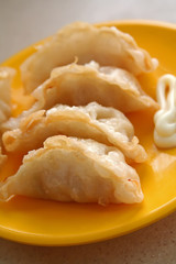 A plate of scrumptous asian dumplings in a japanese restaurant.
