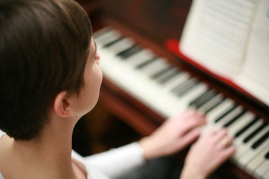 Teenage girl plays piano