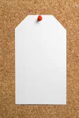 Blank paper tag on cork board background