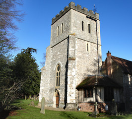 Naklejka premium Medieval English Village Church against a clear blue Winter sky