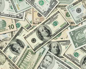 Different American Dollar bills piled together.