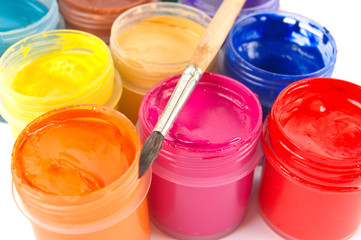 Multicolored gouache paints and paintbrush