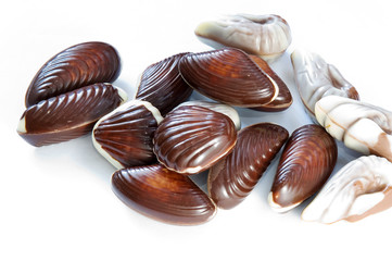 Heap of chocolate candies on white background